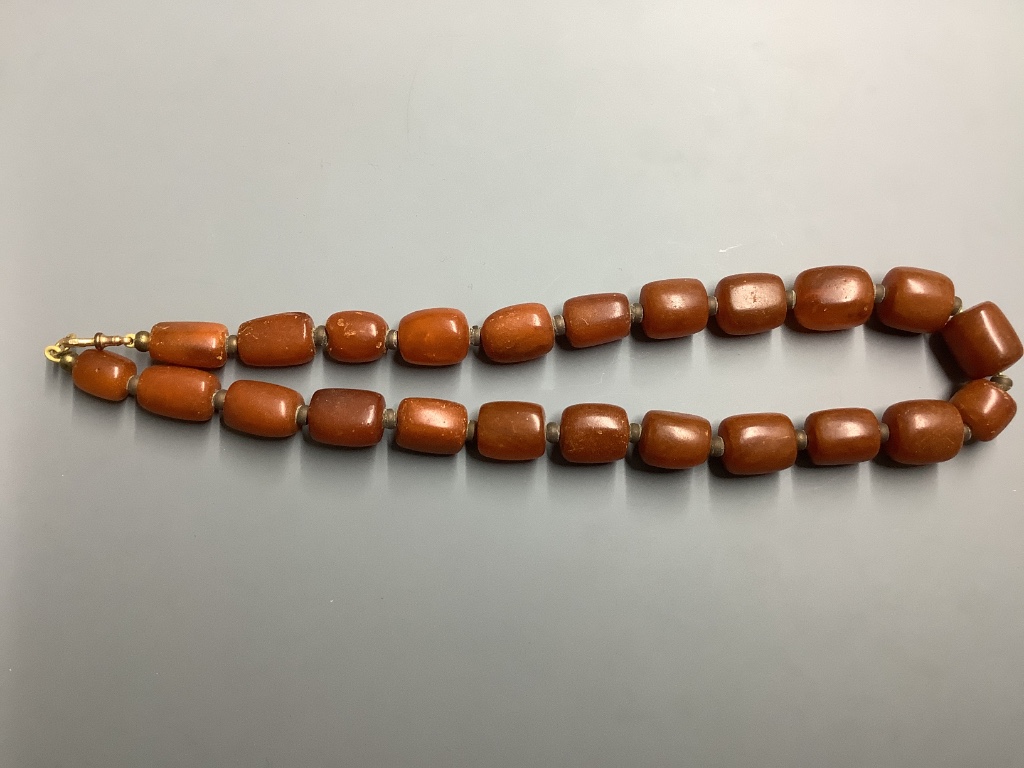 A single strand graduated barrel shaped amber bead necklace, 50 cm, gross weight 89 g.